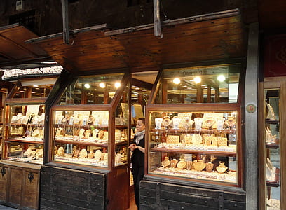 woman standing beside glass display stand thumbnail