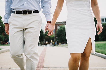 man and woman holding hands together thumbnail