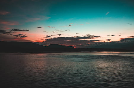 body of water near mountain thumbnail