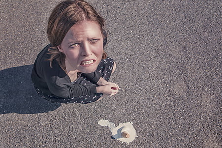 woman sitting on pavement beside ice cream cone thumbnail