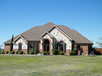 gray and red concrete house under blue sky thumbnail