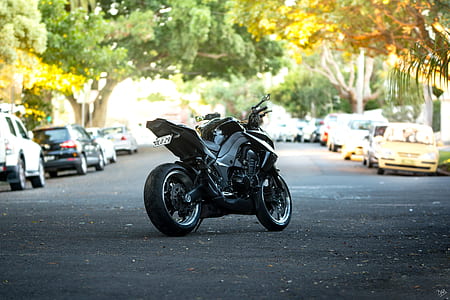 gray sports bike between gray asphalt road thumbnail