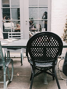 Black Metal Chair Beside Table at Daytime thumbnail