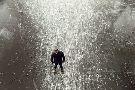 man standing on ice skating rink thumbnail