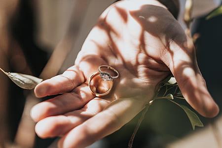 two gold-colored rings on left hand thumbnail