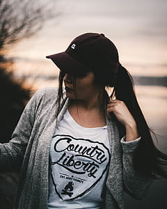 woman wearing black curve-brimmed cap and gray cardigan thumbnail
