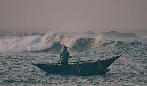 person riding boat on sea near sea wave thumbnail