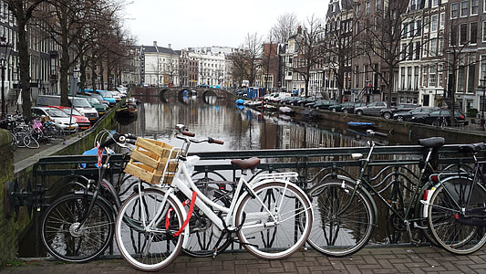 parked bicycles on bridge beside river thumbnail