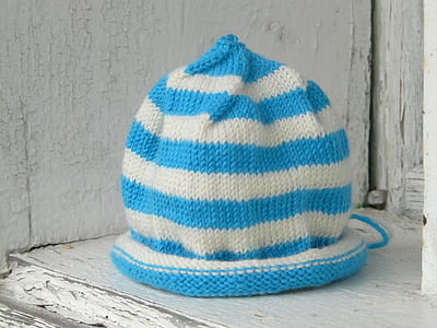 knitted cap on white wooden surface thumbnail