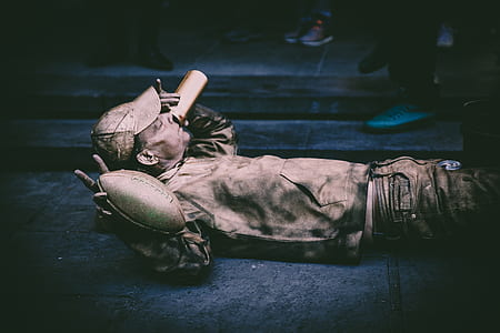 man lying on grey concrete floor thumbnail