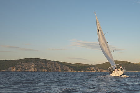 white sailing boat about to sink photo thumbnail