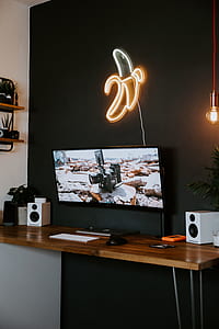 black flat screen computer monitor on brown desk thumbnail