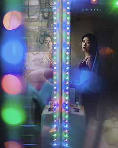 woman standing inside room with lights thumbnail