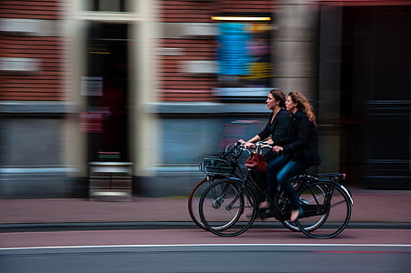 panning photography of two women cycling thumbnail