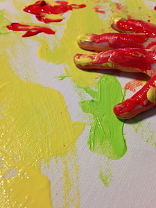 yellow and green paint on canvass and red paint on person's hand thumbnail