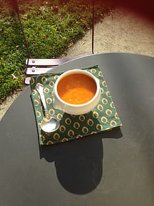 white ceramic cup with saucer and spoon at table thumbnail