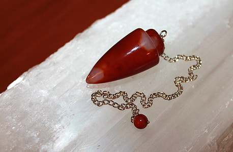 red stone fragment pendant with gold-colored necklace thumbnail