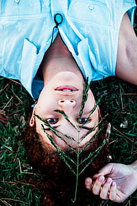 woman lying on the grass during day thumbnail