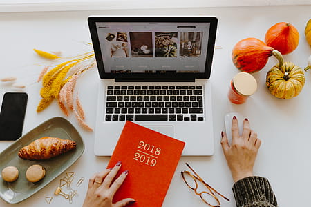 Female desk with orange notebook and pumpkins thumbnail