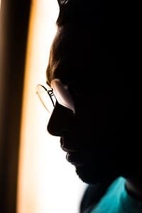 silhouette photography of man wearing eyeglasses in room thumbnail
