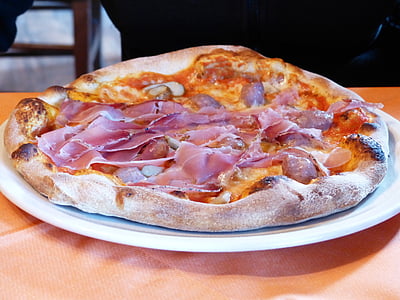 pizza on tray in front of person thumbnail