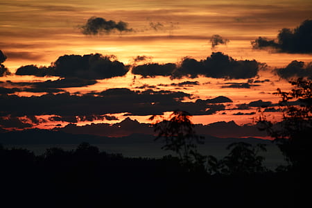 silhouette photo of clouds at golden hour thumbnail