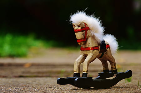selective focus photography of brown and black toy rocking horse thumbnail