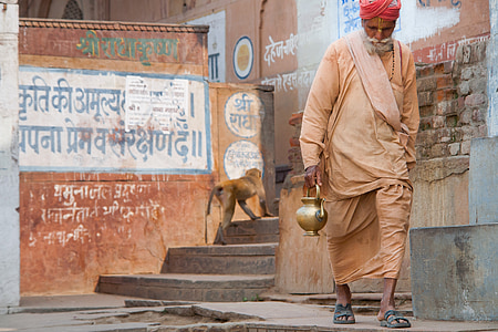 man carrying kettle walking on isle thumbnail