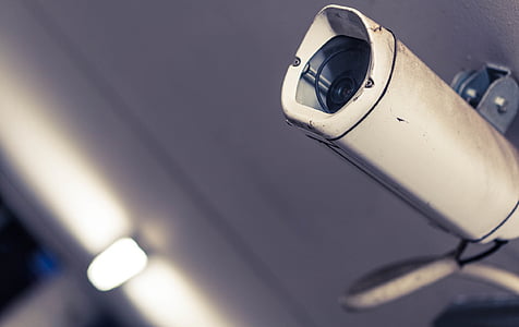 black security camera mounted on wall thumbnail