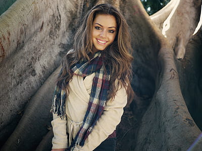 woman wearing beige coat and plaid scarf under treer thumbnail