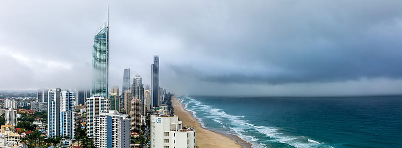 high-rise building near calm body of water during daytime thumbnail