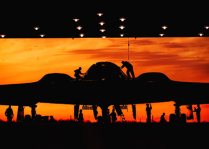 silhouette photography of group of people fixing aircraft thumbnail