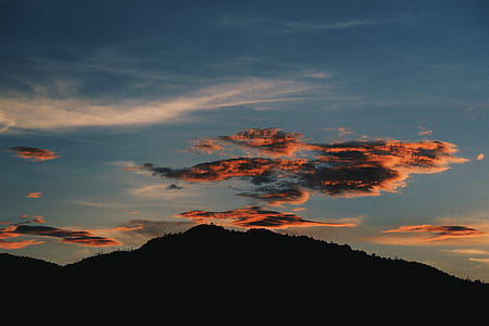 clouds over mountain during sunset thumbnail