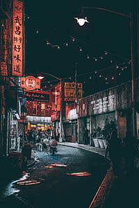 people walking in the street during night time thumbnail