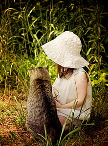 girl and cat lying on grasses thumbnail
