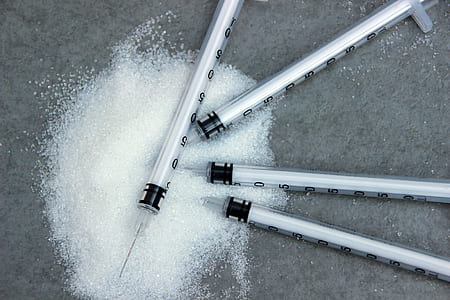 four white syringes beside white substance thumbnail
