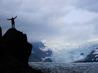 person on top of mountain in front of mountain thumbnail