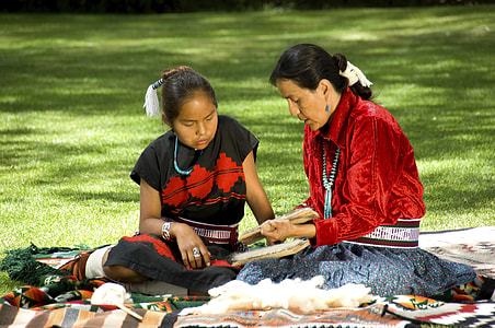 women sitting on green grass thumbnail