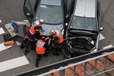two blue and silver vehicle on road with four person thumbnail