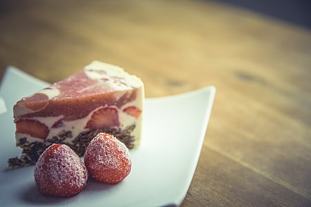 selective focus photography of sliced pie beside strawberries on square white ceramic plate thumbnail
