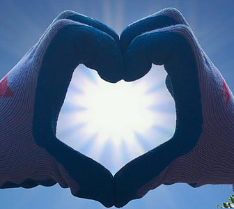 person wearing gloves doing heart hand sign thumbnail