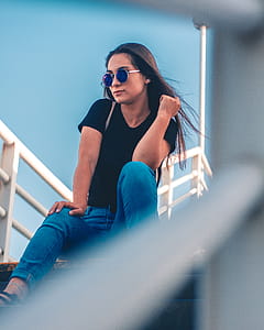 Woman Sitting On Stairs Posing For Photo thumbnail
