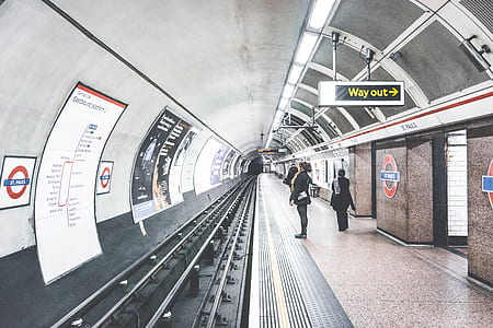 woman wearing black coat standing near train thumbnail