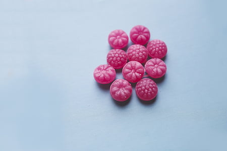 round pink candies on blue panel thumbnail