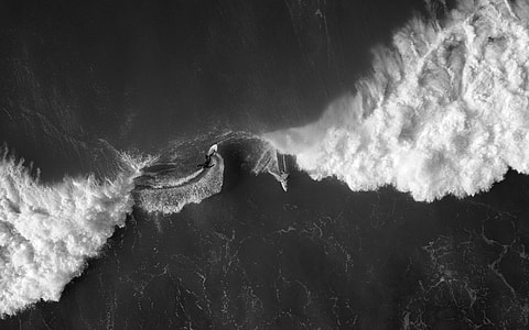 grayscale and aerial view photography of ocean wave thumbnail