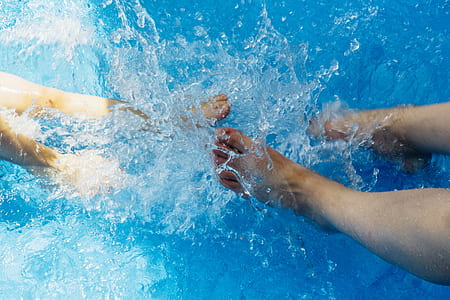 two pairs of feet splashing water thumbnail