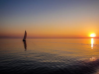 sailing boat against golden suin thumbnail
