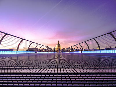 landscape photography person walking on bridge during daytime thumbnail