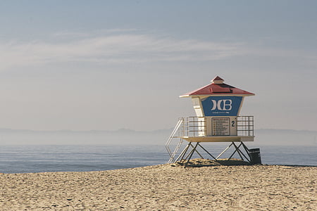 white and blue lifeguard tower on beach shore thumbnail