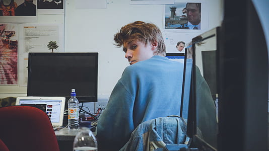 man sitting in front of computer monitor thumbnail